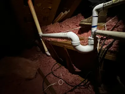 Attic new bathroom pipes during bathroom plumbing work.