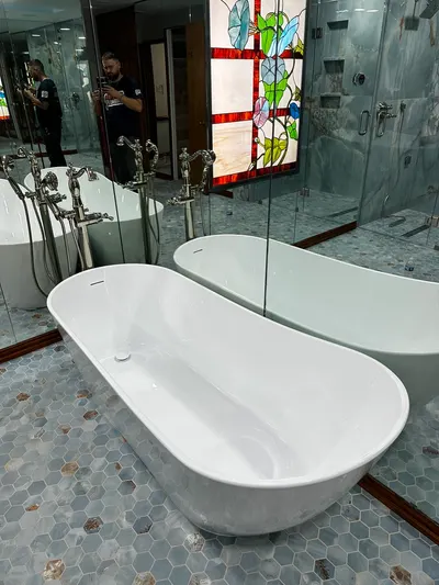 New bathtub and shower installation during bathroom plumbing work.