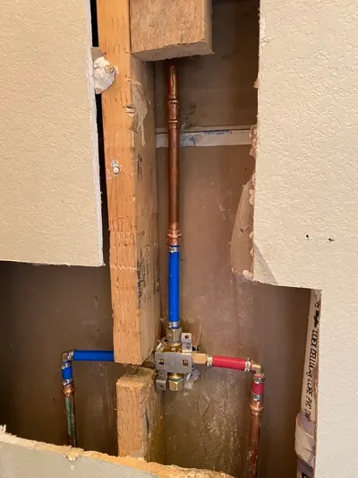 New supply lines for shower during bathroom plumbing work.