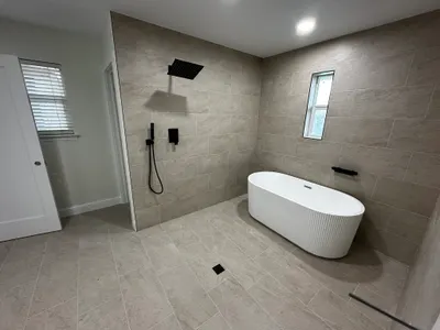 New shower and tub during bathroom plumbing work.