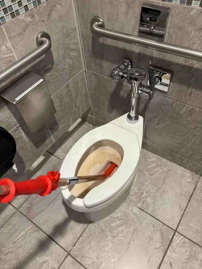 Auger out toilet during a drain cleaning call.