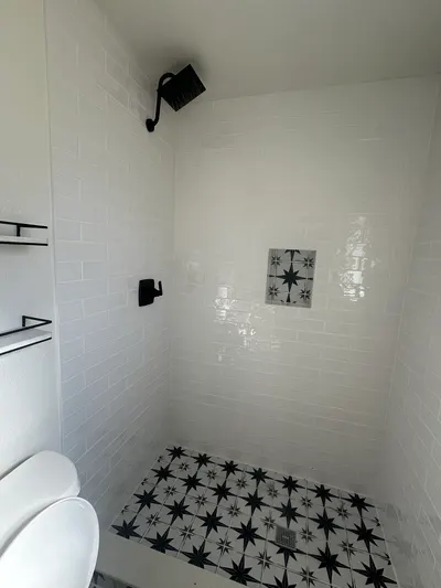 New square shower head bathroom during a fixture installation.