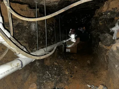 Suspend pipe from slab during sewer line work.