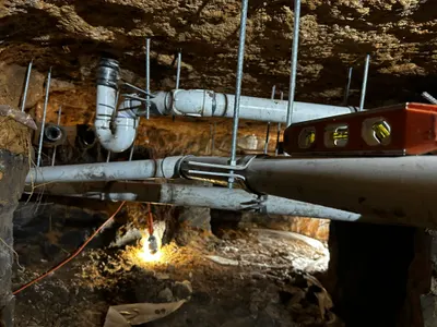 Under slab replacement sewer pipes during sewer line work.