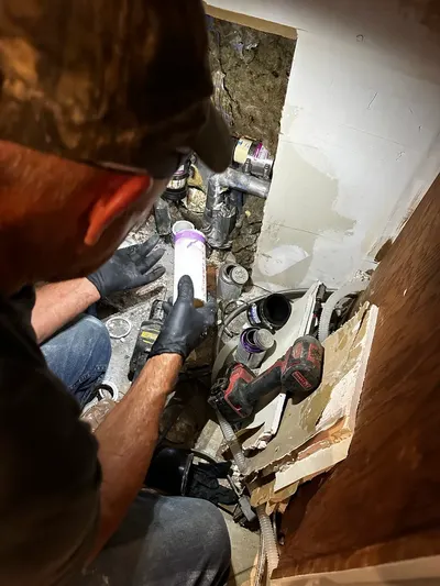 Repair sewer line in wall during sewer line work.