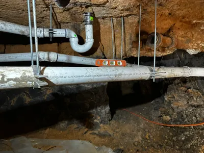 Replace sewer lines under slab during sewer line work.