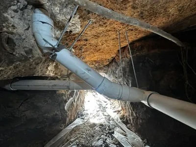 Replace under slab sewer pipes with supports during sewer line work.