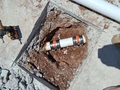Fix leak under concrete flexible joint during a slab leak repair.