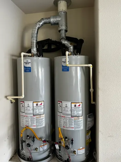 Dual hot water heaters new during a water heater installation.