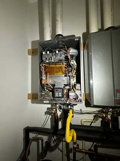Two tankless water heaters during a water heater installation.