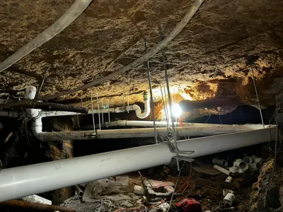 Total replacement pipes under slab during a whole-house repipe.