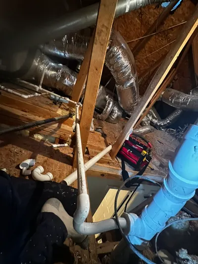 New insulated supply lines routed through attic framing alongside HVAC ductwork.